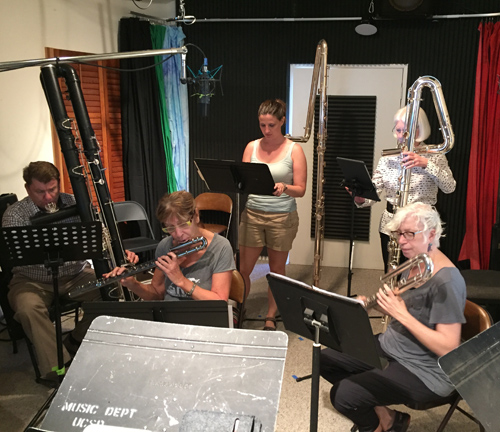 Low end flutists getting ready to record.